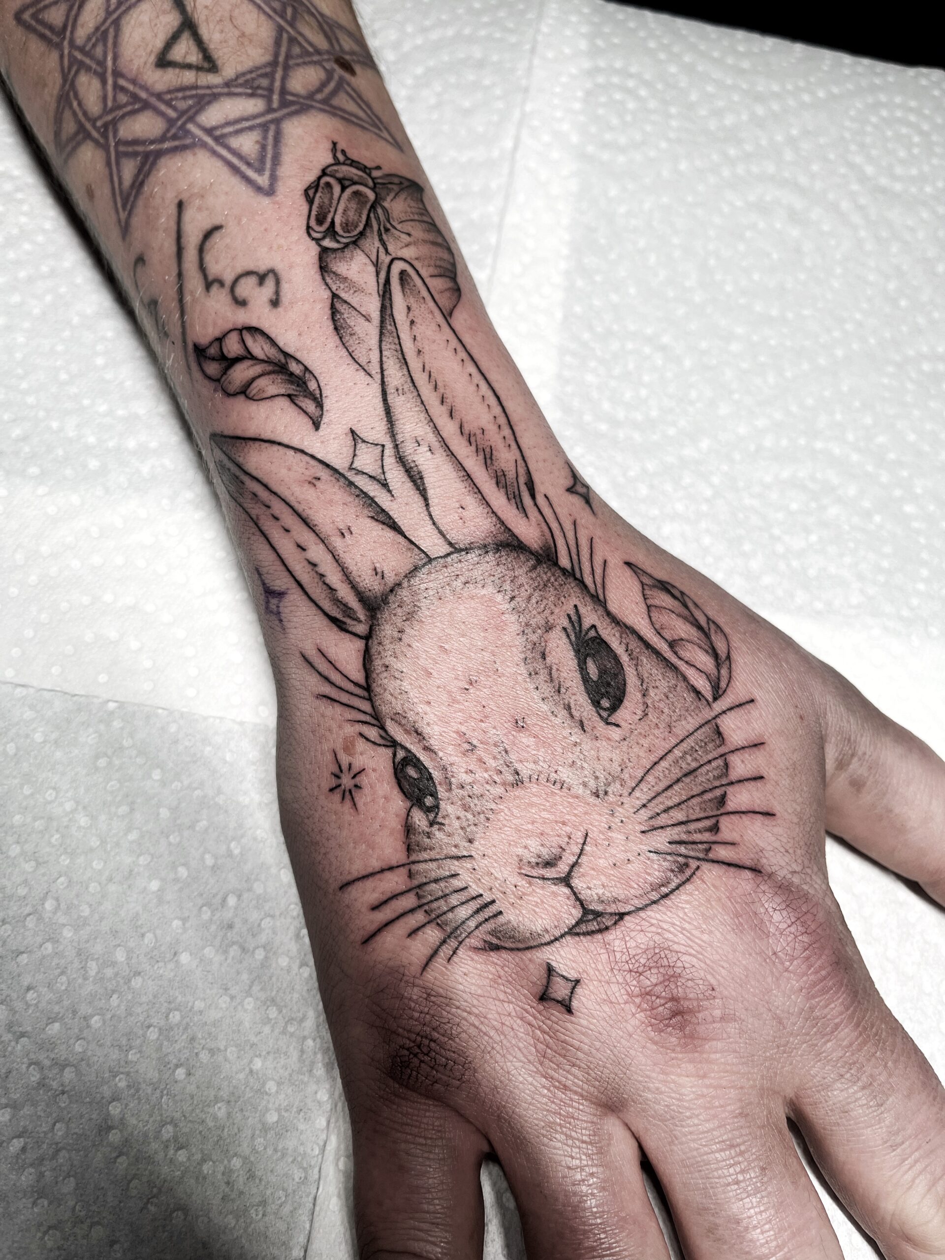 Fineline konijn tattoo op hand, gezet door Famke (Ocean Tattoo) bij True Spirit Tattoo Barendrecht